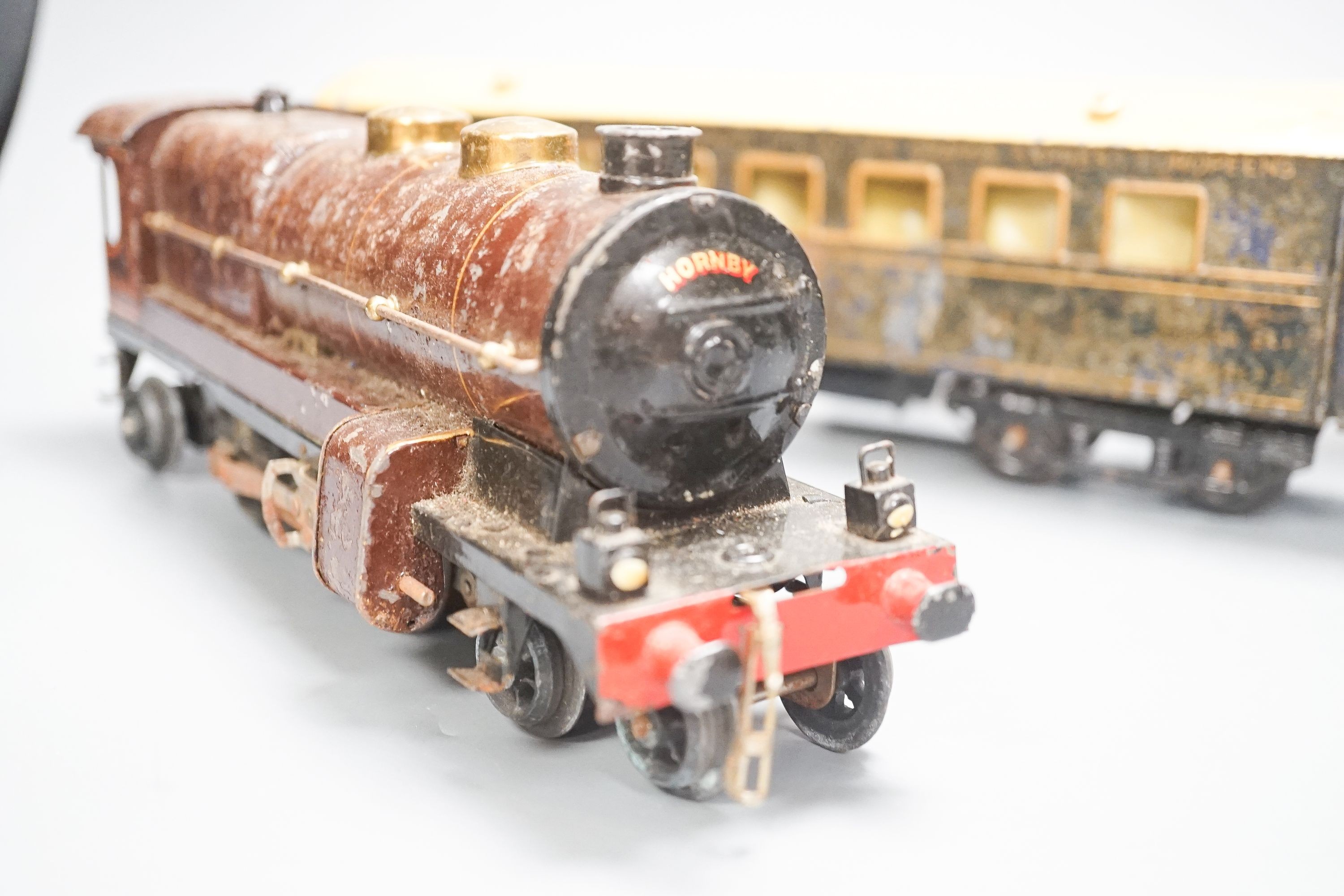 A small collection of Hornby tinplate O gauge clockwork engines and carriages etc